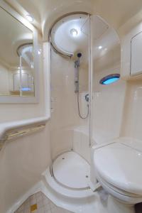 a bathroom with a toilet and a shower at Luxury Yacht Hotel in Gibraltar