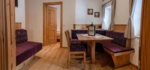 a room with a table and two chairs and a table at Bauernhof Krahlehen - B&B - Apartments in Filzmoos +40 photos