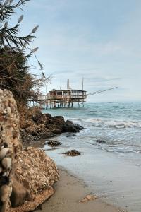 a pier on the beach with the ocean at Casa Verde Oliva - WelcHome in Rocca San Giovanni +13 photos