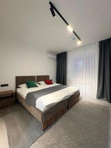 a bedroom with a large bed and a window at Avenue Hotel in Almaty