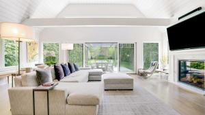 a living room with a couch and a fireplace at Villa Mist Manor in East Hampton