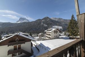 a view of the mountains from the balcony of a building at Ciasa Remo 2 by WelcHome in San Vito di Cadore