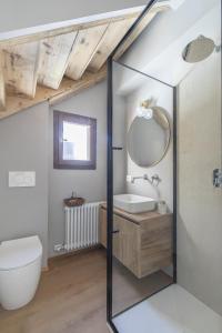 a bathroom with a toilet and a mirror at Ciasa Remo 2 by WelcHome in San Vito di Cadore +32 photos