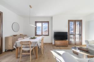 a living room with a table and a couch at Ciasa Remo 2 by WelcHome in San Vito di Cadore