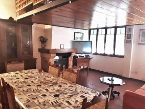 a living room with a table and a fireplace at Biogarden in Zelarino