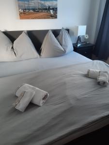 a white bed with two pillows on it at Ferienwohnung Engel in Romanshorn