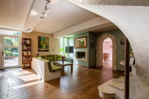 a living room with a couch and a table at Le Domaine de Rose in Lourdes