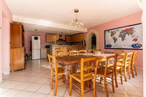 a kitchen and dining room with a table and chairs at Le Domaine de Rose in Lourdes