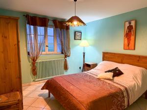 a bedroom with a bed and a window at Le Domaine de Rose in Lourdes +31 photos