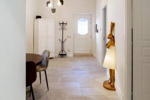 a hallway with a table and chairs and a door at Le Finestre su Villa d'Este in Tivoli +16 photos