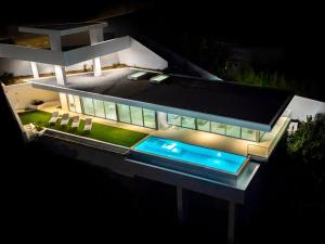 a night view of a house with a pool at Villa Gia in Calheta