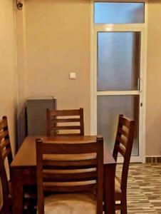 a dining room with a table and chairs and a window at River point inn in Arusha