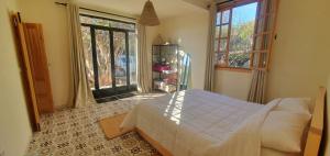 a bedroom with a bed and a large window at Villa Assalama Mogador, Essaouira in Essaouira +49 photos