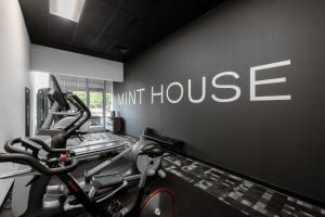 a gym with two tread machines and a unit house at Mint House Greenville Downtown By Kasa in Greenville
