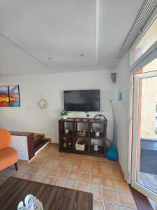 a living room with a flat screen tv on the wall at Amazing duplex Las Americas in Costa de Adeje