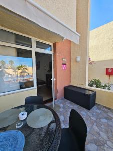 a patio with a table and chairs in front of a building at Amazing duplex Las Americas in Costa de Adeje