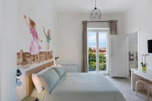 a bedroom with a bed with a wall mural of two women at GRIMALDI ROOMS Costa d'Amalfi in Pagani