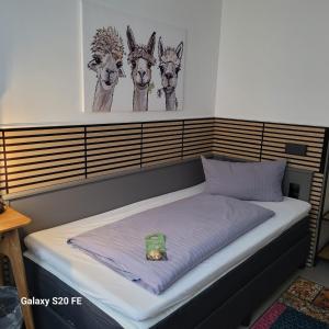 a bed with a box on top of it at Parkhotel Schwedt in Schwedt