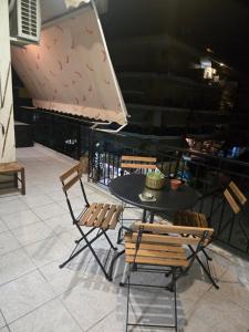 ein schwarzer Tisch und Stühle und ein Tisch und Stühle in der Unterkunft NeliFlat in Lefkandi Chalkida