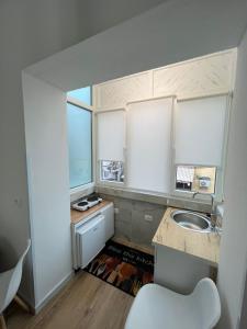 a small kitchen with a sink and a window at E&B Cosy Apartment 6 in Tirana