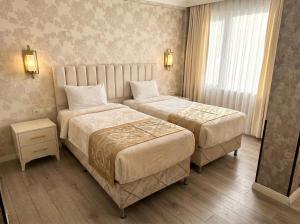 a hotel room with two beds and a window at B Corner Hotel Bistro in Istanbul +28 photos