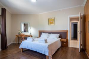 a bedroom with a bed with towels on it at Villa Atlantica in Setúbal +75 photos