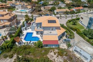 an aerial view of a house with a swimming pool at Villa Atlantica in Setúbal