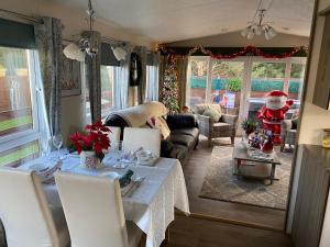 a living room with a couch and a table at Longstone Lodge in Morpeth