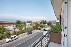 a white car parked on the side of a city street at GRIMALDI ROOMS Costa d'Amalfi in Pagani