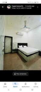 a bedroom with a bed in a room at Shri shyam hotel and restorent in Govardhan +9 photos