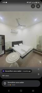 a screenshot of a bedroom with a bed and a table at Shri shyam hotel and restorent in Govardhan