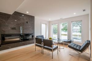 a dining room with a glass table and a piano at 4Br 3 Bath Oceanview Modern Home in Halifax