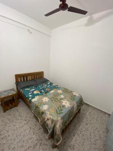 a bedroom with a bed and a ceiling fan at HoneyBee 2BHK Homestay Agonda in Agonda