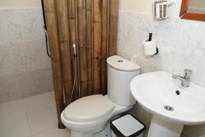 a bathroom with a white toilet and a sink at Azuls Tourist Inn in San Vicente