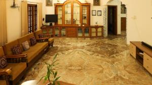 a living room with a floor covered in water at Spacious 3-Bedroom Private Villa in Mangalore - Ideal Getaway for Family and Friends in Mangalore +56 photos