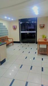 a living room with a white tiled floor at AP Ventidor in Guarapari