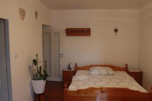 a bedroom with a wooden bed and a plant at Lucka in Ústí nad Labem