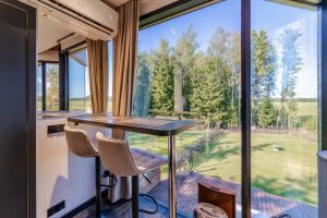 a room with a table and chairs and a large window at Luxury Resort Kabuna in Kabuna
