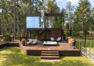 a wooden deck with a glass house in a yard at Luxury Resort Kabuna in Kabuna +15 photos