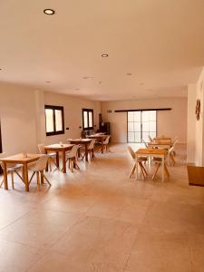a large room with wooden tables and chairs at Casa Kirana - Habitaciones in Bermeo