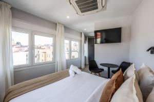 a hotel room with a bed and a window at Password to Malasaña in Madrid