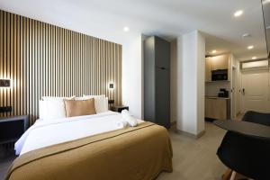 a bedroom with a bed with a teddy bear on it at Password to Malasaña in Madrid +18 photos