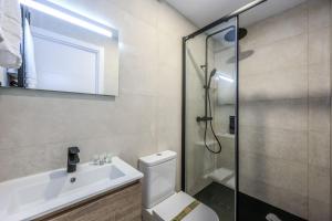 a bathroom with a shower and a toilet and a sink at Password to Malasaña in Madrid