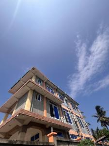 a tall building with a blue sky in the background at PhyllenHotel Tanga in Tanga +23 photos