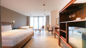 a hotel room with a bed and a desk at Garrya Romo Hotel in Urla +145 photos
