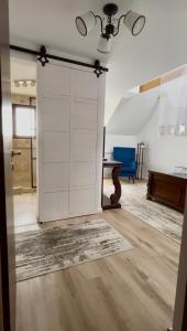 a sliding door in a living room with a table at Pensiunea Ivoire in Avrig +55 photos
