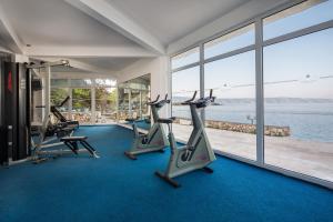 a gym with cardio machines and a view of the water at Fontana Resort in Jelsa