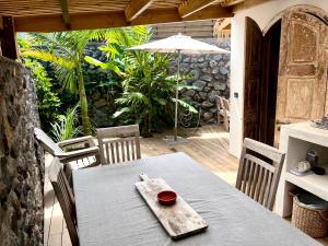 a table with a bowl on it on a patio at Paillote Plume Bleue in Saint-Leu