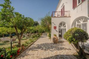 a walkway in front of a white building at Dimora Filangieri in Massa Lubrense
