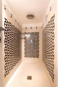 a hallway with black and white tiles on the wall at Dimora Filangieri in Massa Lubrense +47 photos